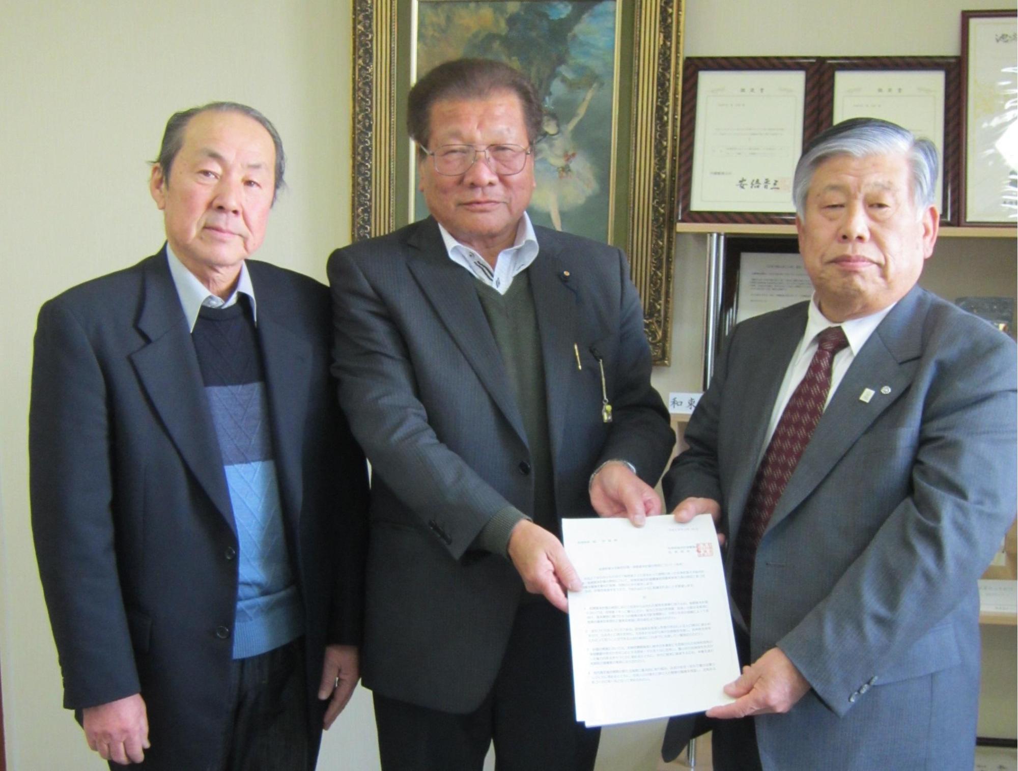 町長と岡田会長が書類を一緒に持ち久保副会長と3人で写っている写真